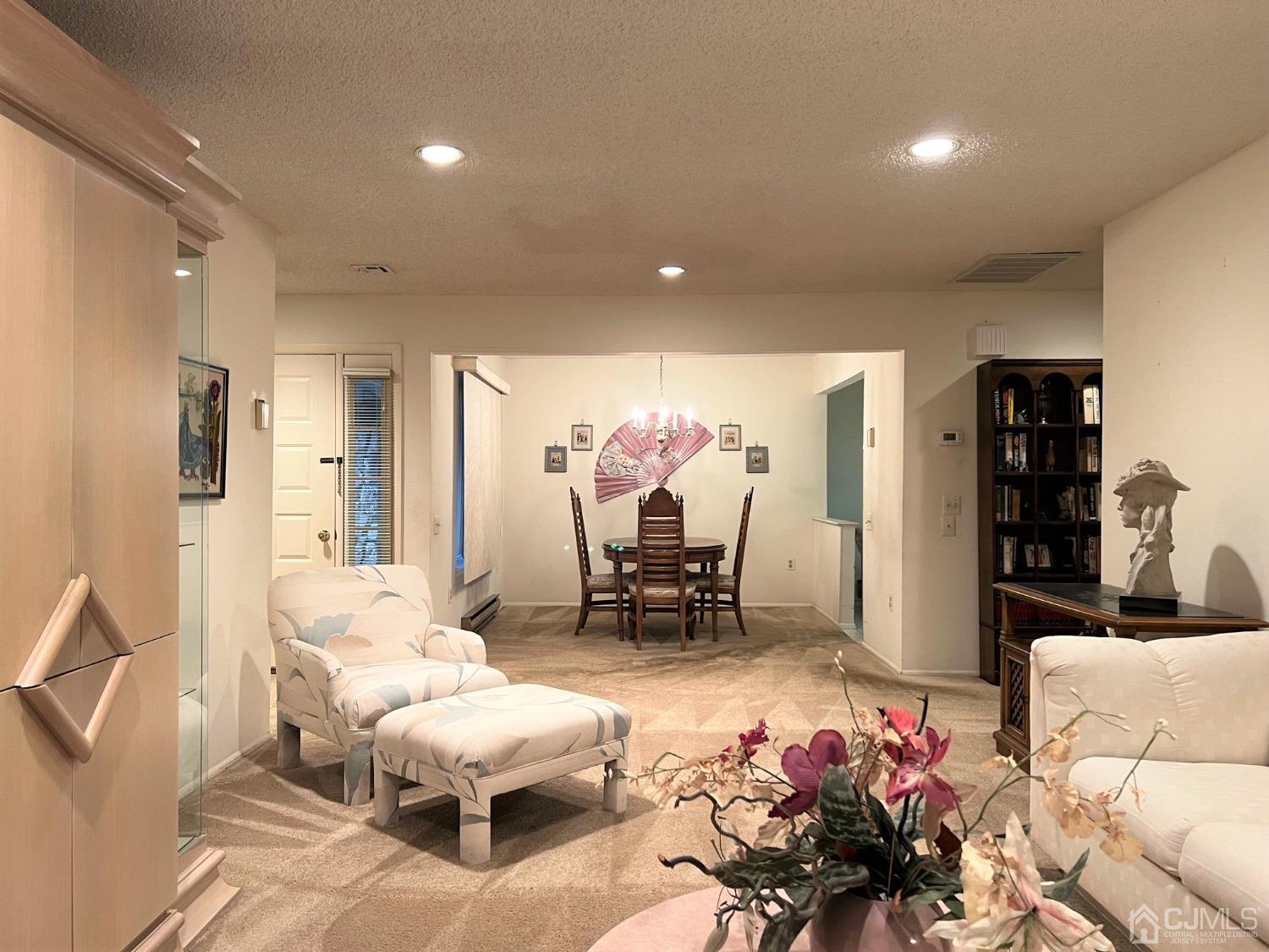 783B Risley Road, Unit A Monroe Township, NJ 08831 - Photo 5 of 30 a living room with furniture and a chandelier