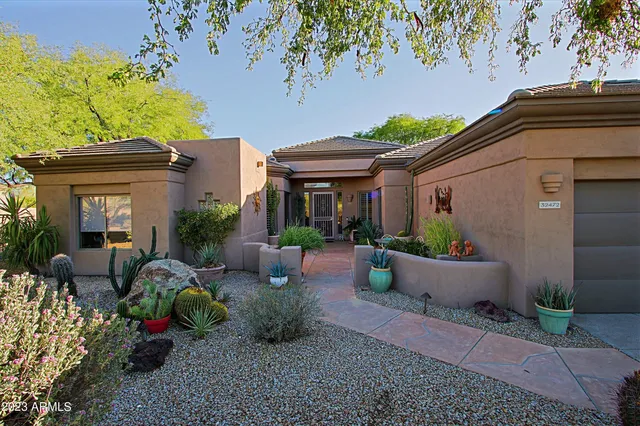 a front view of a house with potted plants