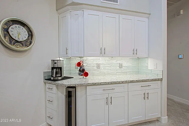 a bathroom with a granite countertop double vanity and mirror