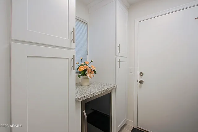 a bathroom with a granite countertop sink a toilet a mirror a vanity and shower