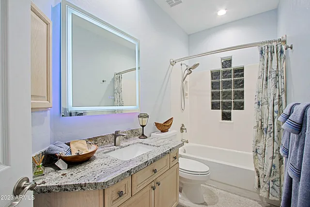 a living room with furniture a rug and a chandelier