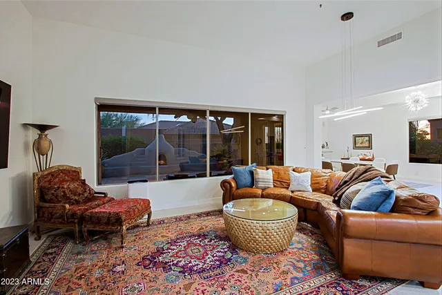 a living room with kitchen island furniture and a flat screen tv