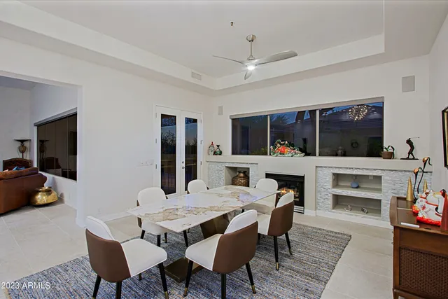 a kitchen with stainless steel appliances kitchen island granite countertop a stove a sink dishwasher and white cabinets with wooden floor