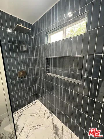 a bathroom with a sink toilet shower and a tub