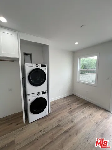 a view of a kitchen with a stove and wooden floor