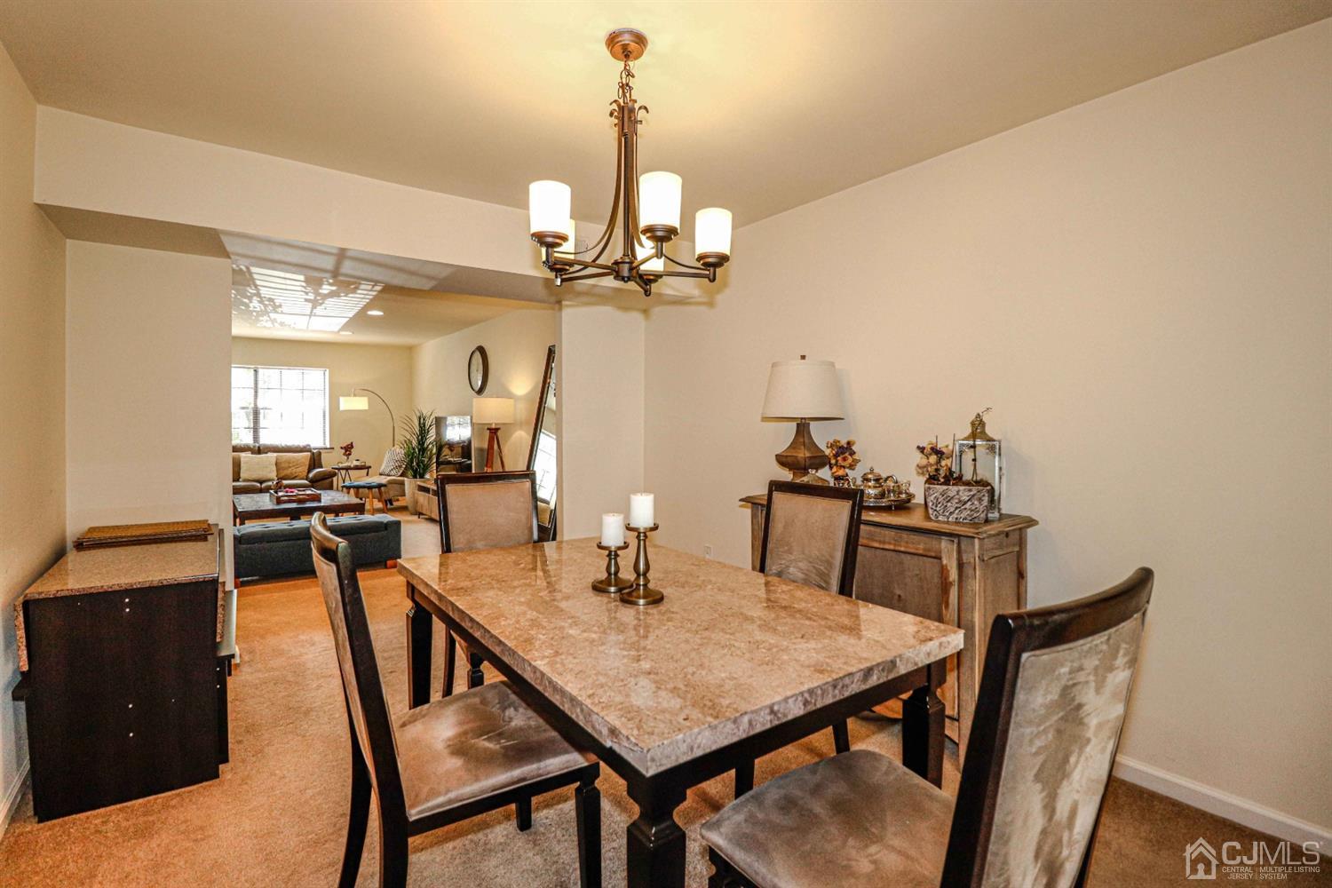 5702 Hana Road Edison, NJ 08817 - Photo 11 of 30 a view of a dining room with furniture and a chandelier