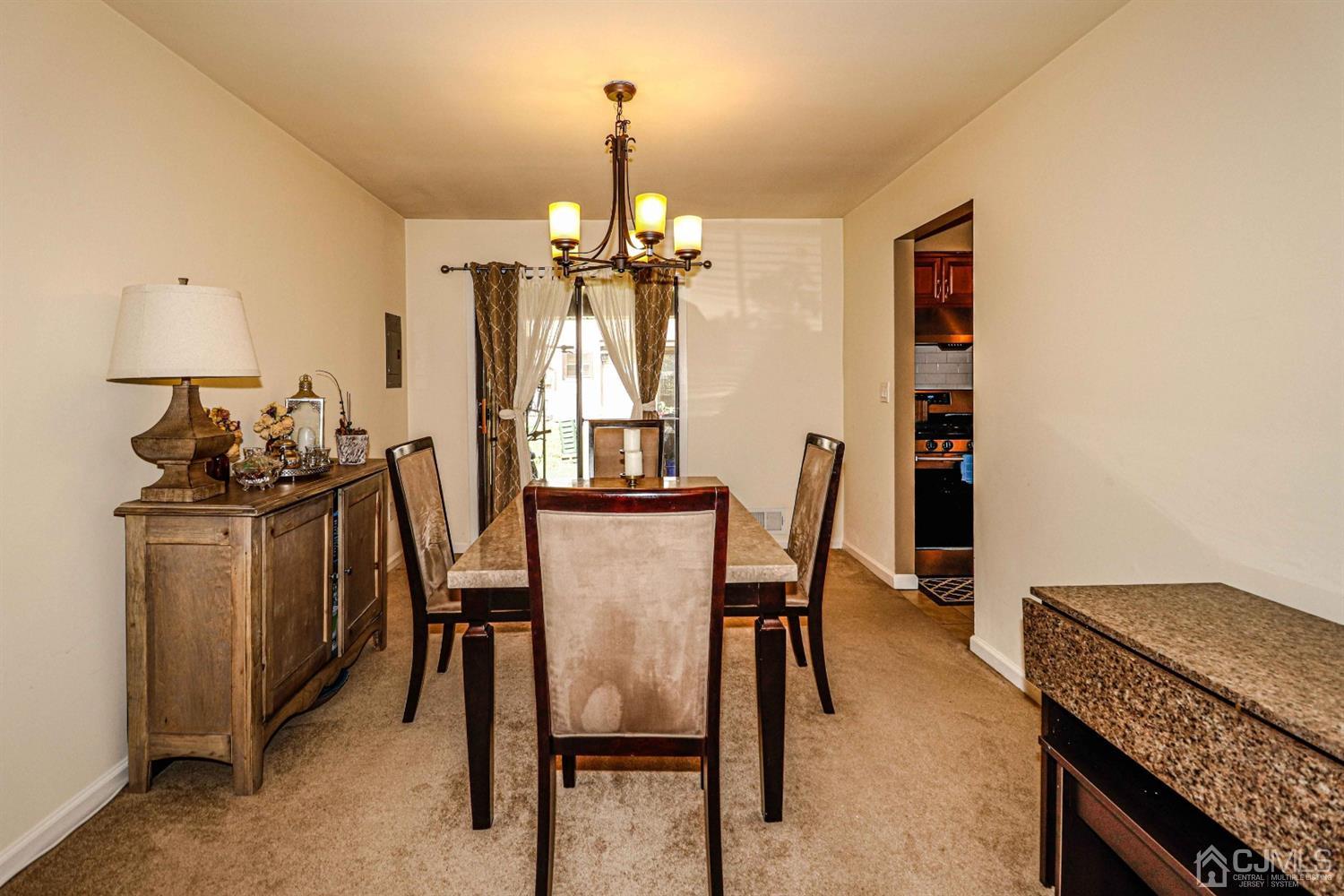 5702 Hana Road Edison, NJ 08817 - Photo 12 of 30 a view of a dining room with furniture and chandelier