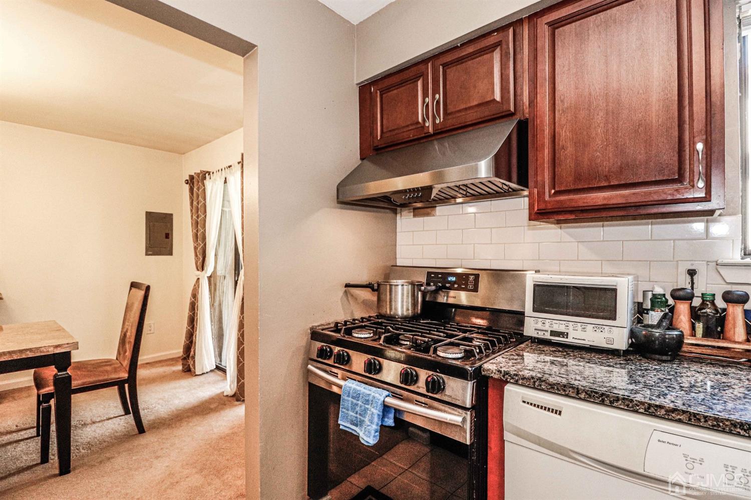 5702 Hana Road Edison, NJ 08817 - Photo 16 of 30 a kitchen with stainless steel appliances granite countertop a stove a sink and a microwave