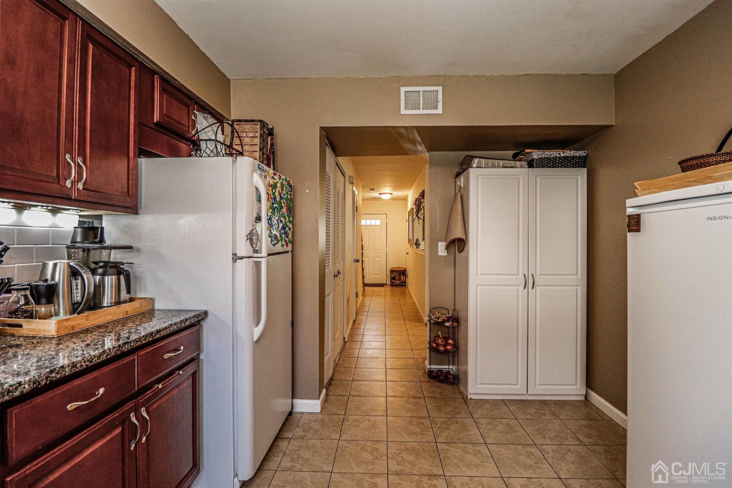 5702 Hana Road Edison, NJ 08817 - Photo 17 of 30 a kitchen with stainless steel appliances granite countertop a refrigerator and a sink