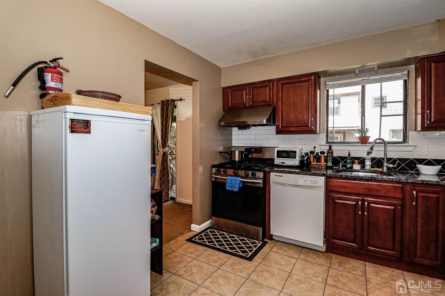 5702 Hana Road Edison, NJ 08817 - Photo 18 of 30 a kitchen with a refrigerator and a stove top oven