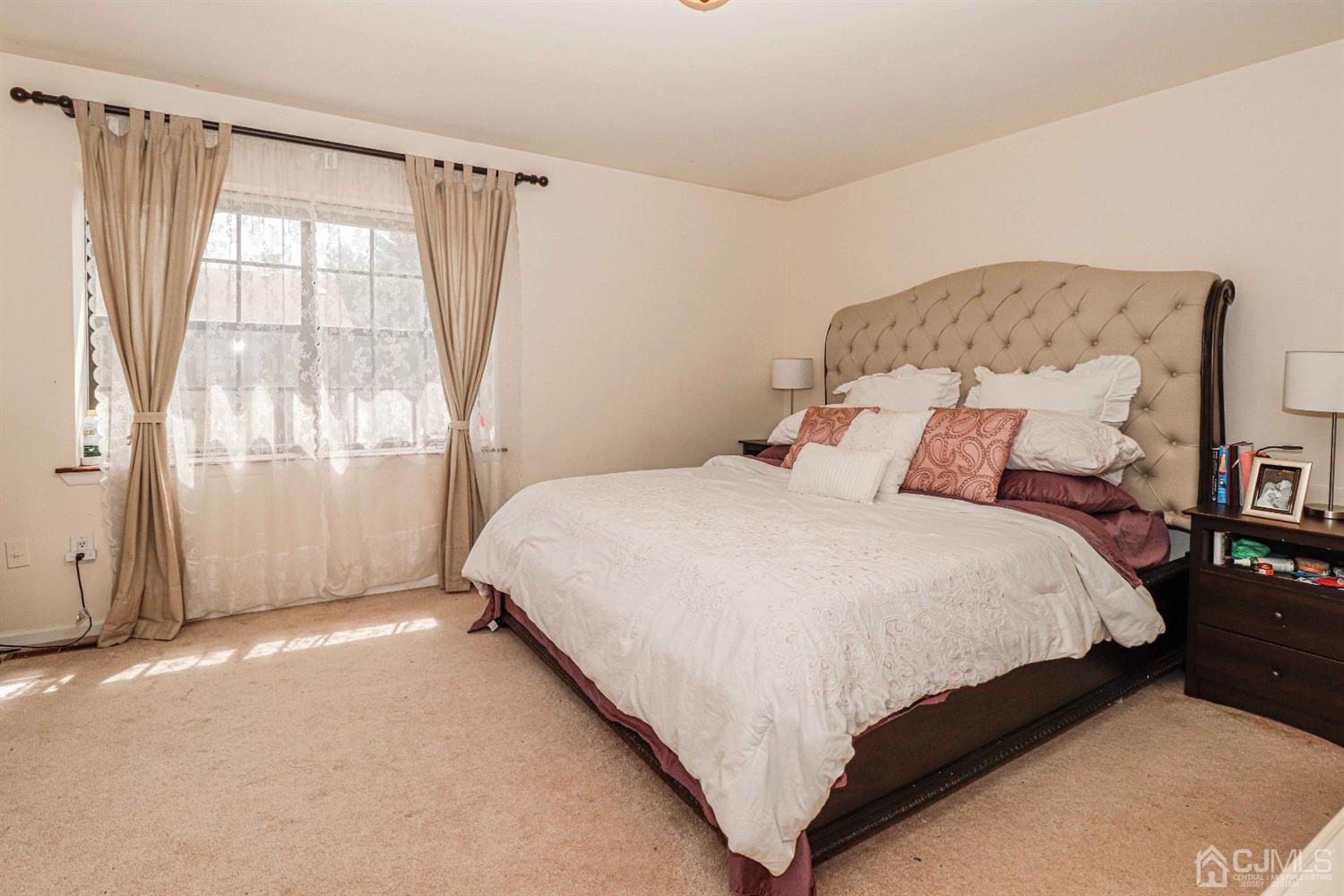 5702 Hana Road Edison, NJ 08817 - Photo 23 of 30 a bedroom with a bed and a window