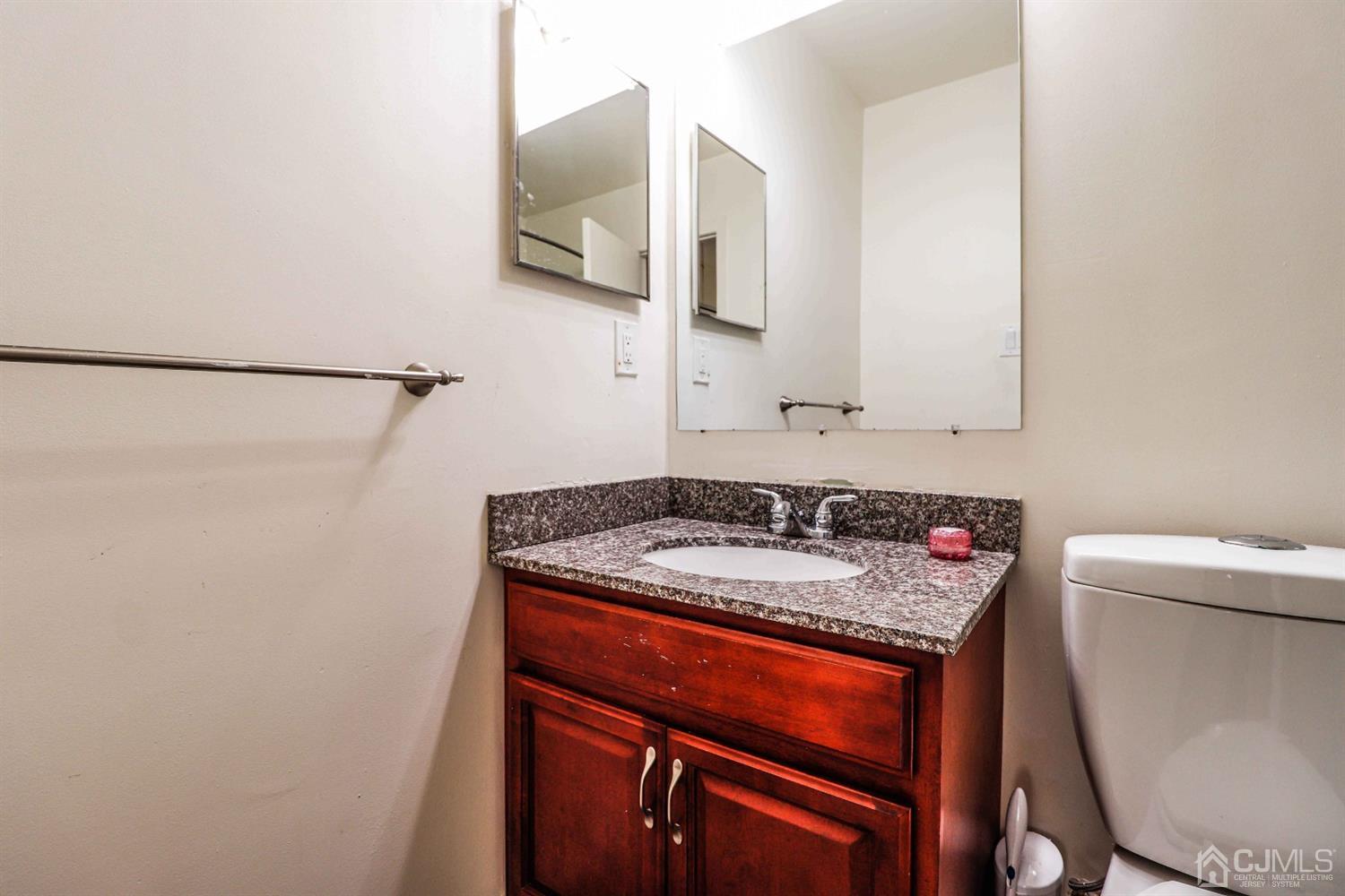 5702 Hana Road Edison, NJ 08817 - Photo 29 of 30 a bathroom with a sink and a mirror