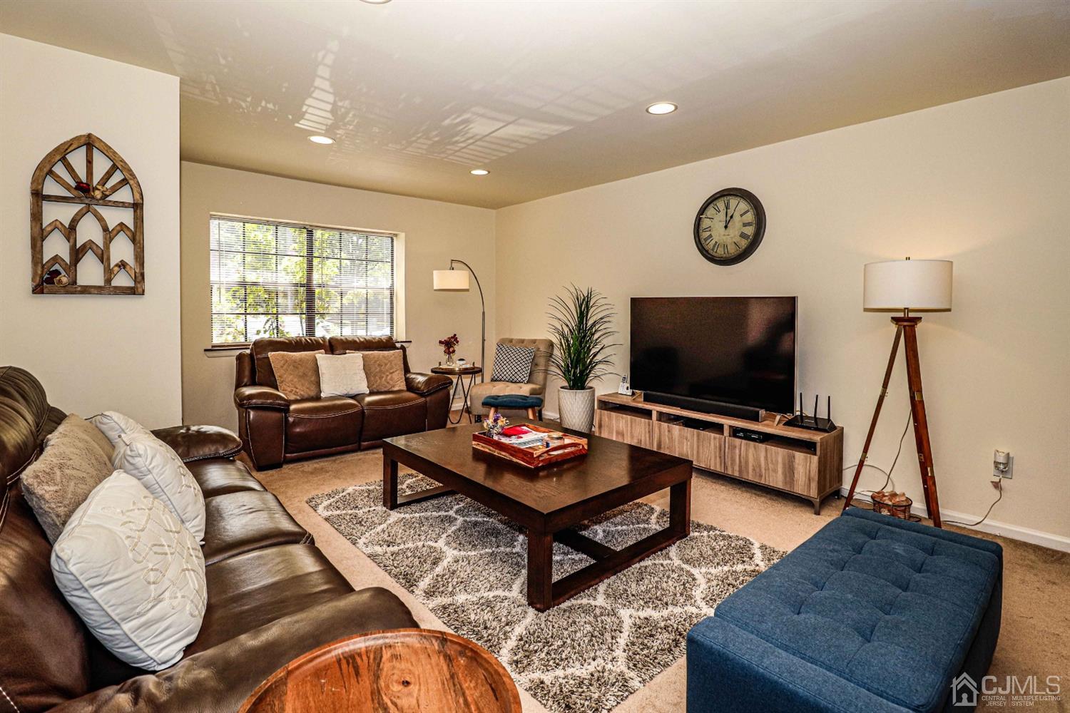 5702 Hana Road Edison, NJ 08817 - Photo 8 of 30 a living room with furniture and a flat screen tv
