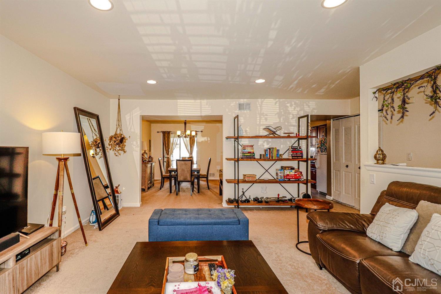 5702 Hana Road Edison, NJ 08817 - Photo 10 of 30 a living room with furniture and a flat screen tv