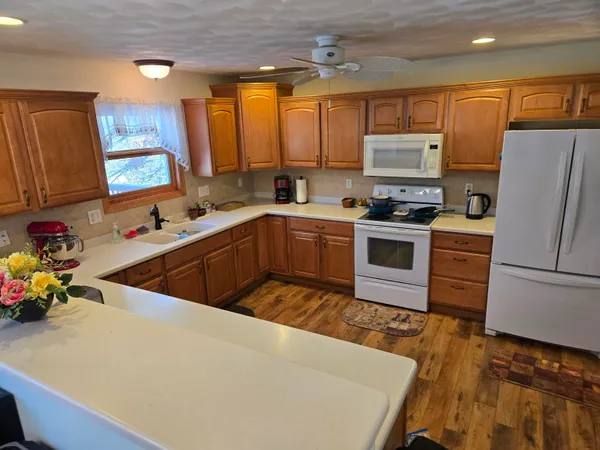 a spacious bathroom with a sink a toilet a mirror and shower