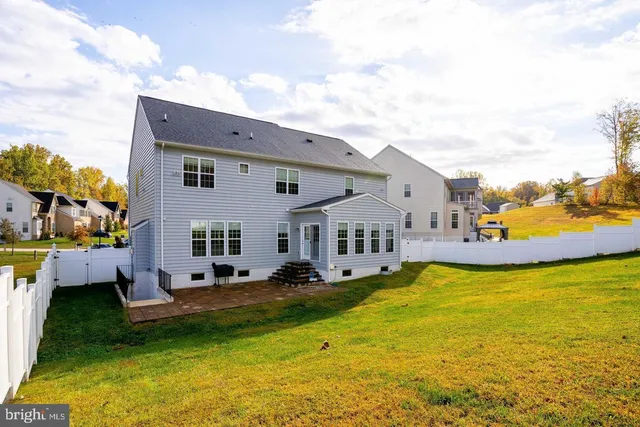 a view of a house with swimming pool and sitting area