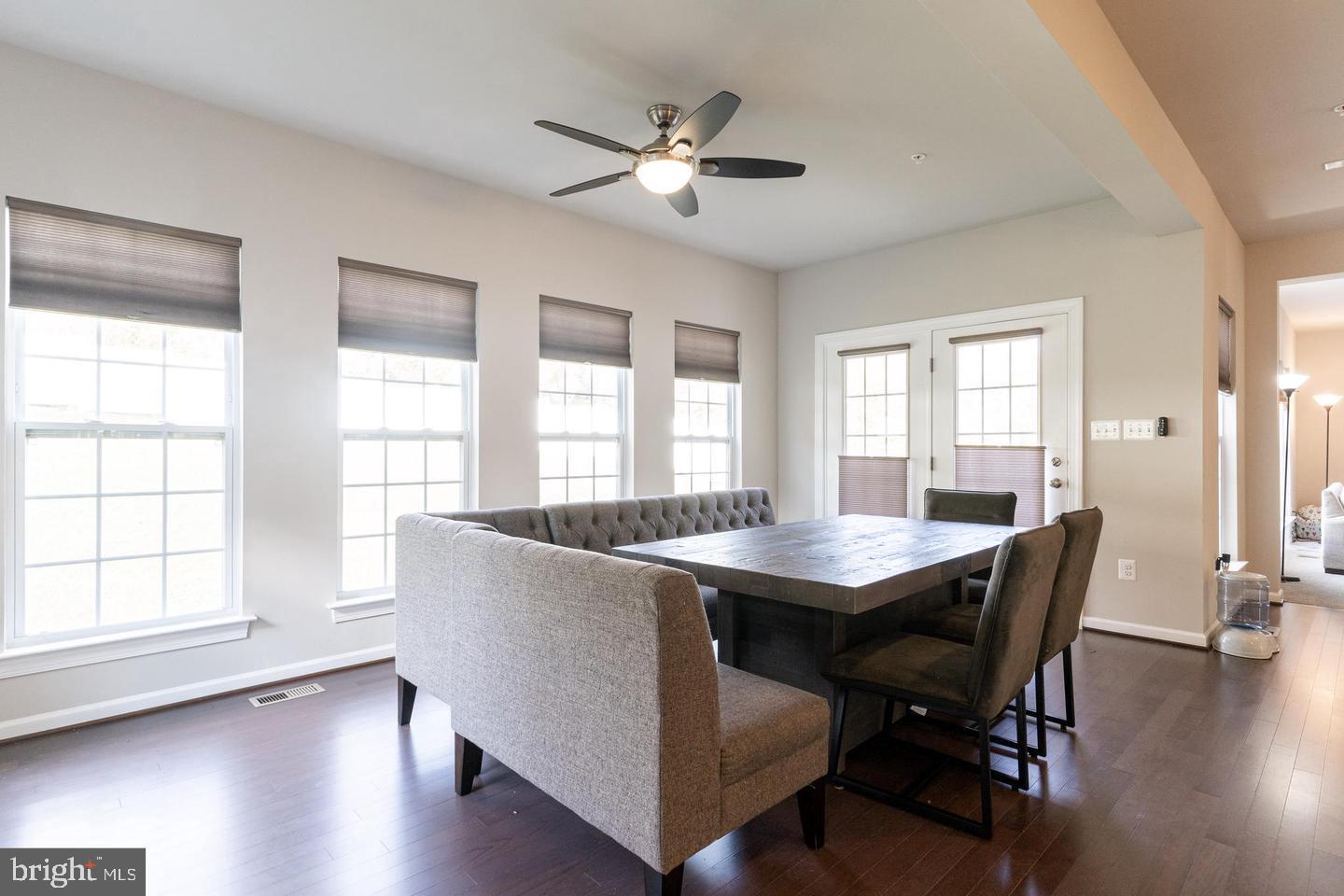 6100 Oglethorpe Mill Drive Brandywine, MD 20613 - Photo 5 of 22 a dining room with wooden floor a chandelier a wooden table and chairs