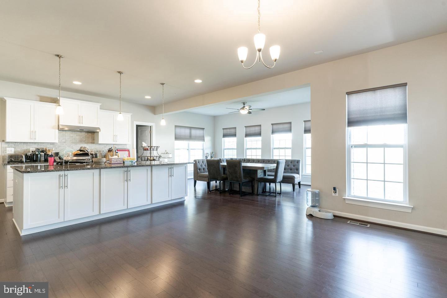 6100 Oglethorpe Mill Drive Brandywine, MD 20613 - Photo 9 of 22 a open kitchen with white cabinets and wooden floor