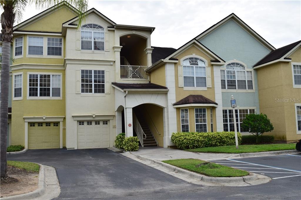 3361 South Kirkman Road, Unit 823 Orlando, FL 32811 - Photo 1 of 1 a front view of a house with a yard and garage