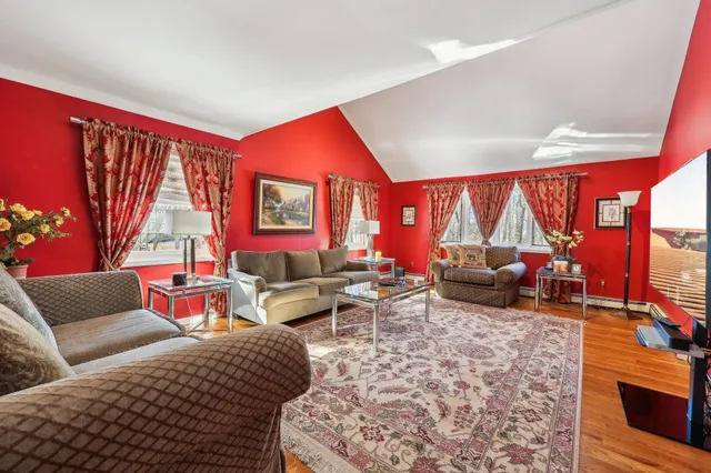 a living room with furniture a rug and a large window