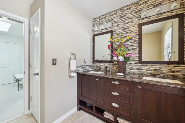 a bathroom with a sink vanity and mirror