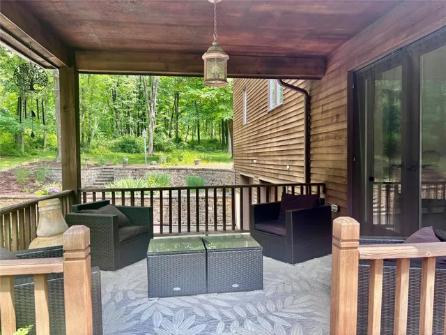 a wooden bench sitting in front of a house