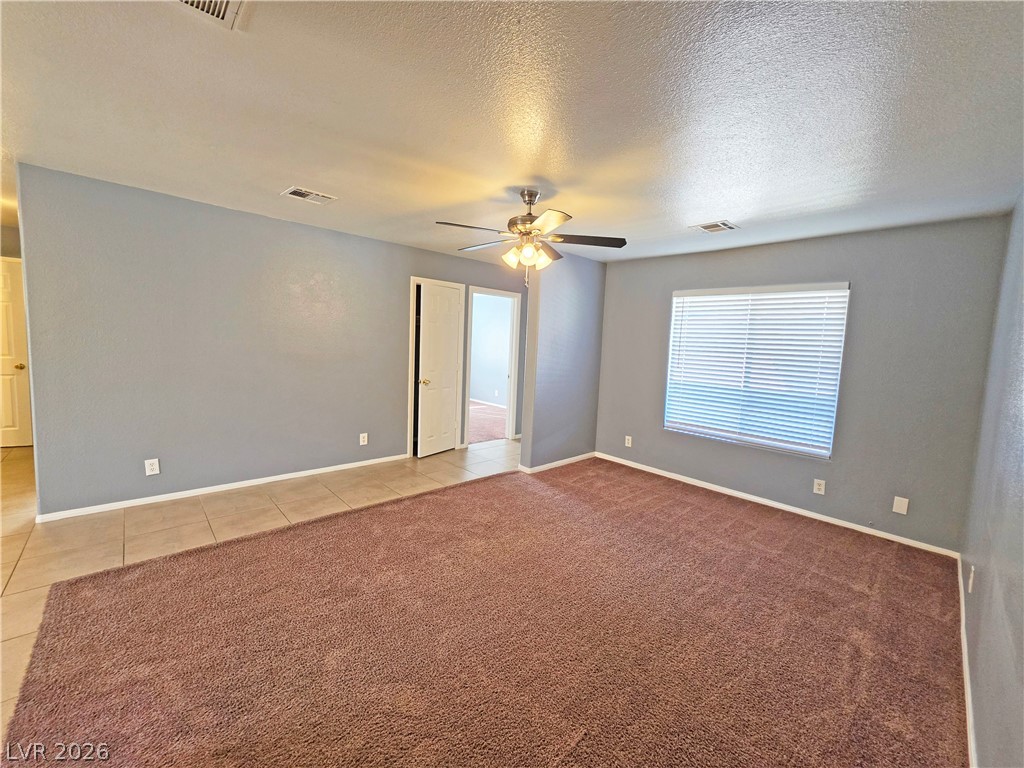 1444 Star Road, Unit 3 Pahrump, NV 89048 - Photo 7 of 35 A spacious room offers comfortable living with a blend of soft carpeting and durable tile flooring.