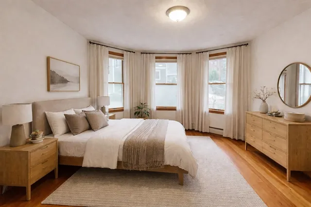 a bedroom with a large bed and a window