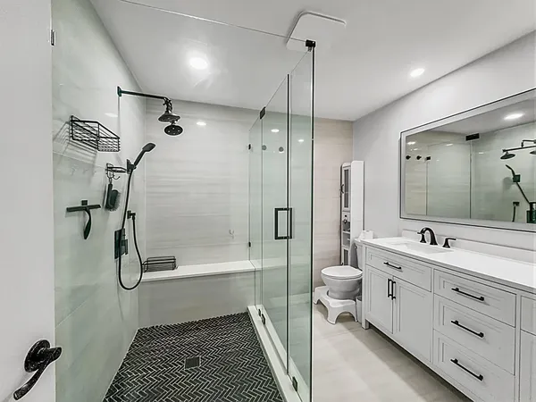 a bathroom with a double vanity sink toilet and shower