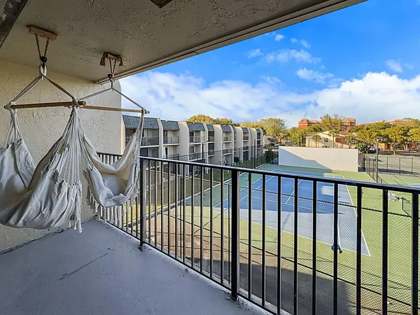 a view of a balcony with a floor to ceiling window and wooden fence