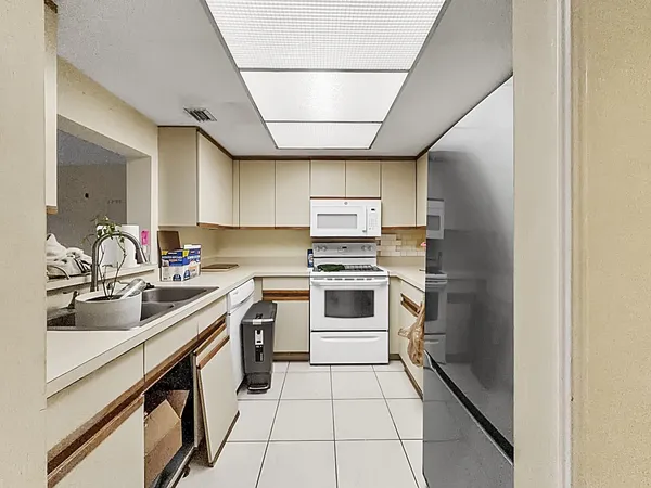 a kitchen with a sink stove and cabinets