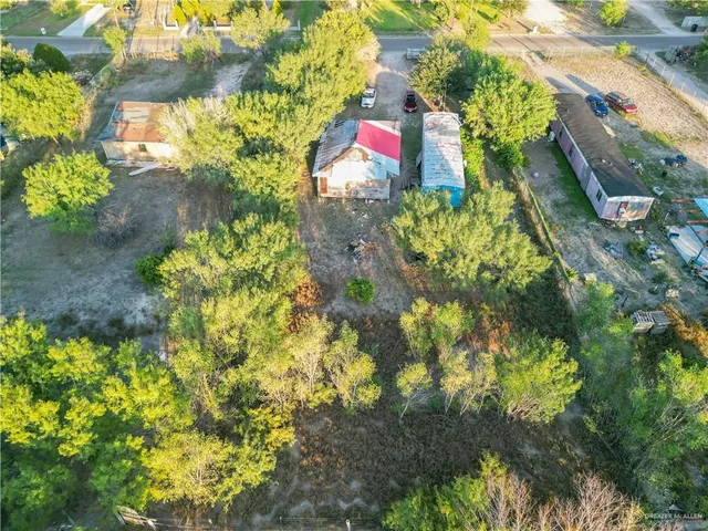 an aerial view of a house with a yard and lake view