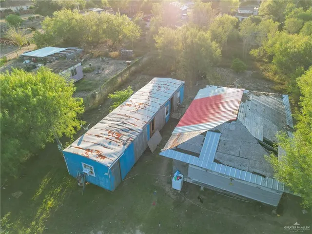 an aerial view of residential houses with outdoor space