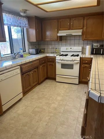 a kitchen with a stove sink and a microwave