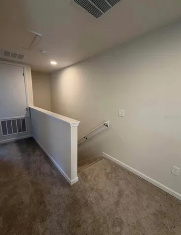 a kitchen with stainless steel appliances kitchen island a refrigerator sink and white cabinets
