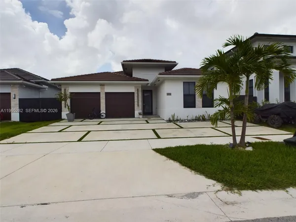 a front view of house with yard and garage