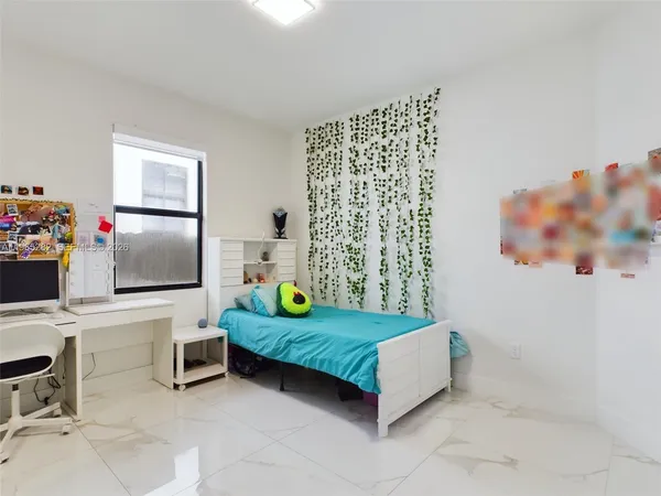 a bedroom with a bed and a desk