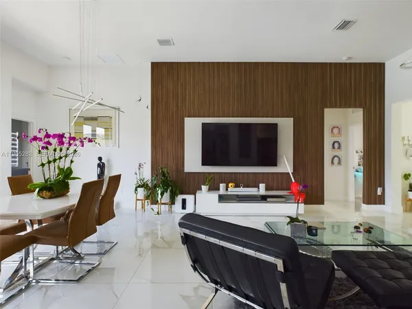 a living room with furniture and flowers