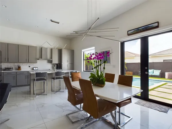 a view of a dining room with furniture and a potted plant