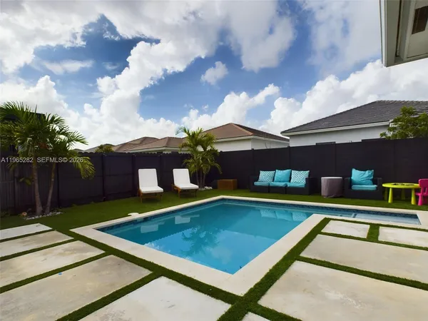a view of swimming pool with seating space