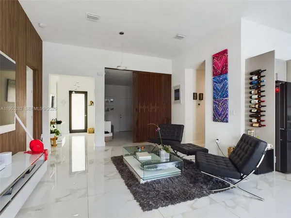 a living room with furniture and flowers