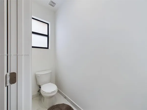 a white toilet sitting next to a white sink