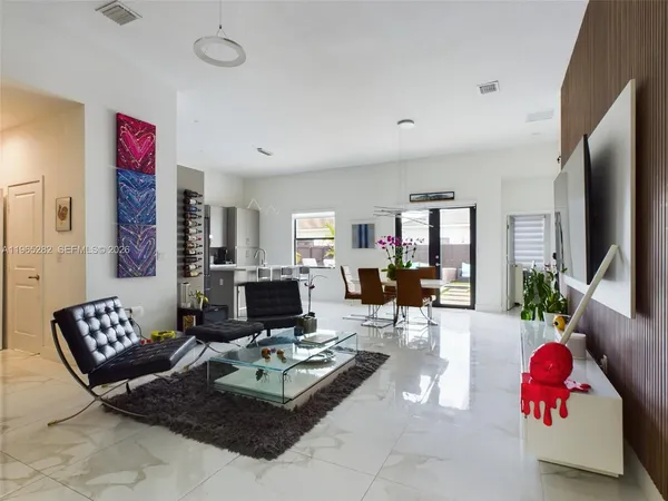 a living room with furniture and a flat screen tv