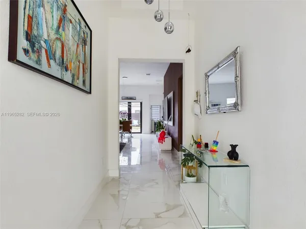 a view of a hallway with dining area and entryway
