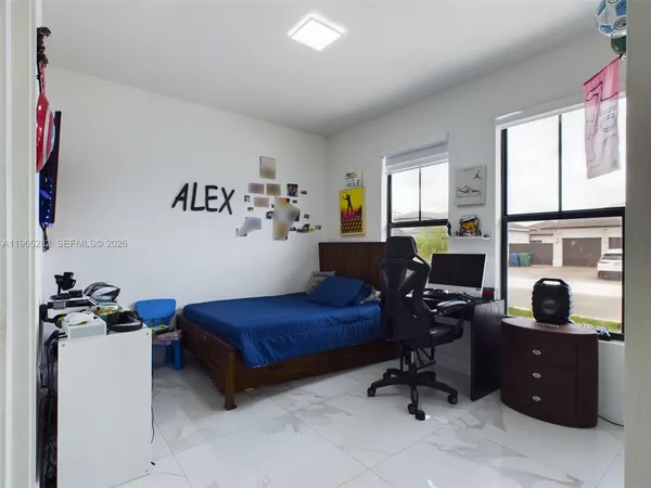 a bedroom with a workspace