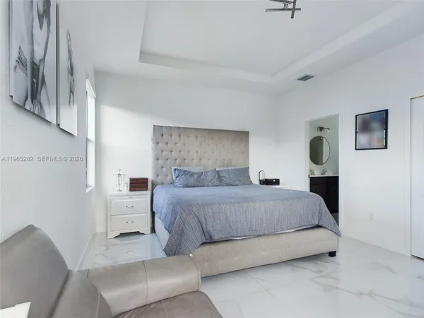 a bedroom with a bed couch and window