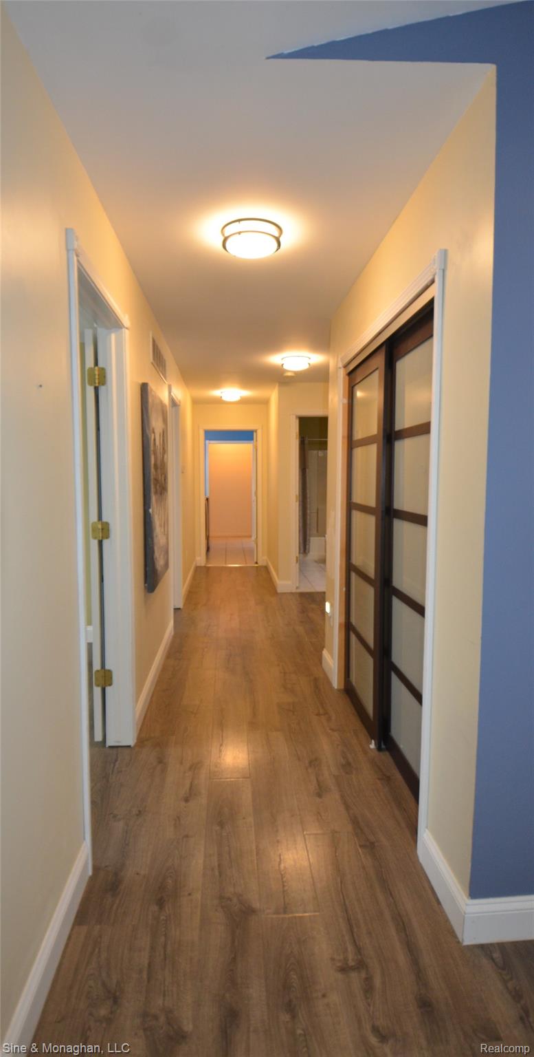 76152 Burman Road Richmond, MI 48062 - Photo 29 of 75 Corridor featuring dark wood-type flooring and baseboards