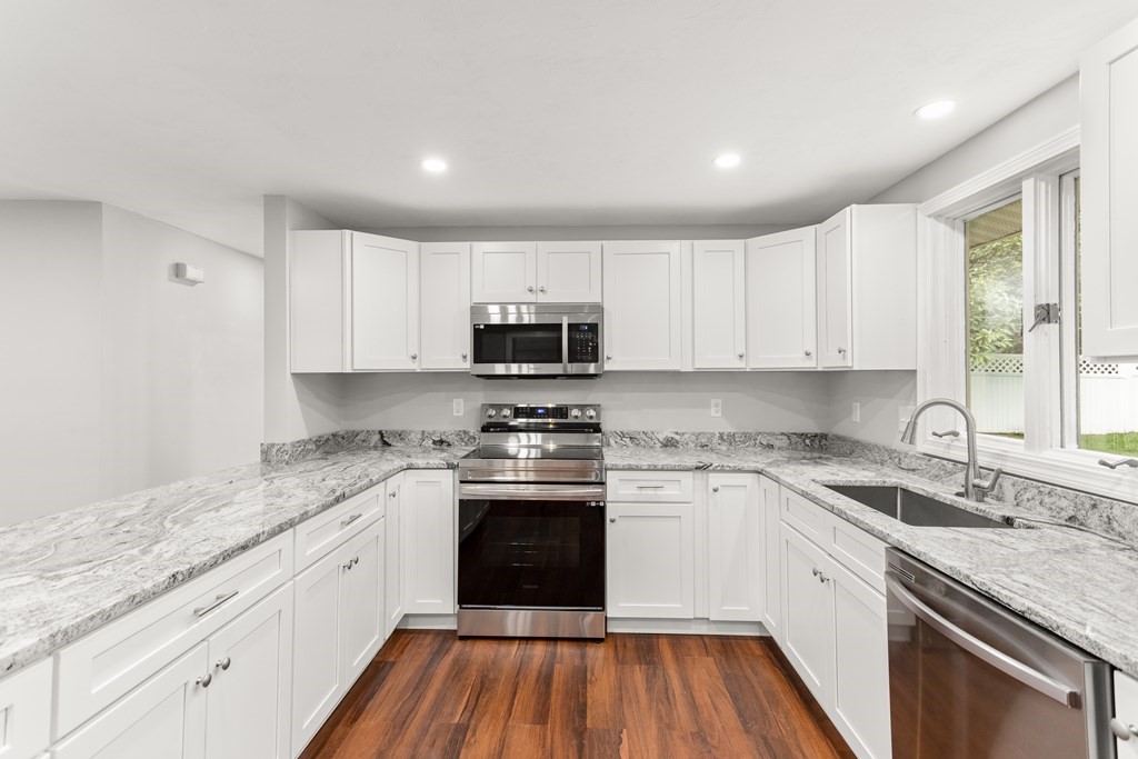 14 Fairbrook Road Framingham, MA 01701 - Photo 14 of 24 a kitchen with granite countertop white cabinets sink and stainless steel appliances