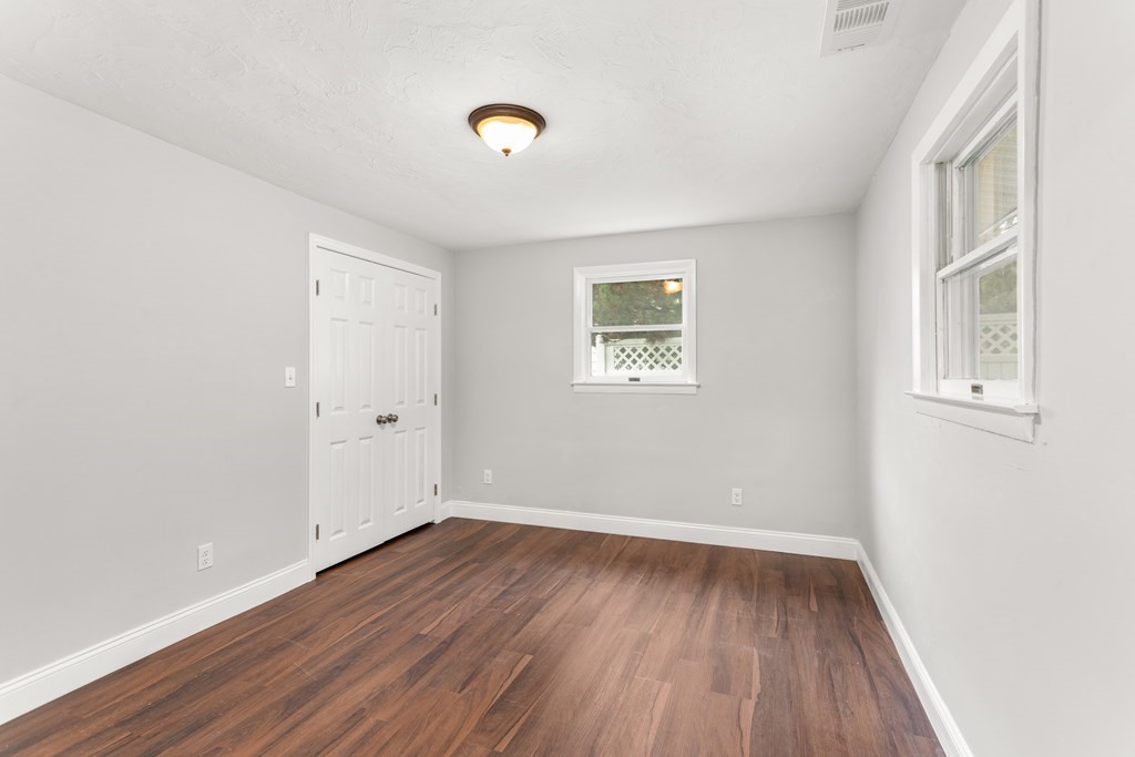 14 Fairbrook Road Framingham, MA 01701 - Photo 18 of 24 an empty room with wooden floor and windows