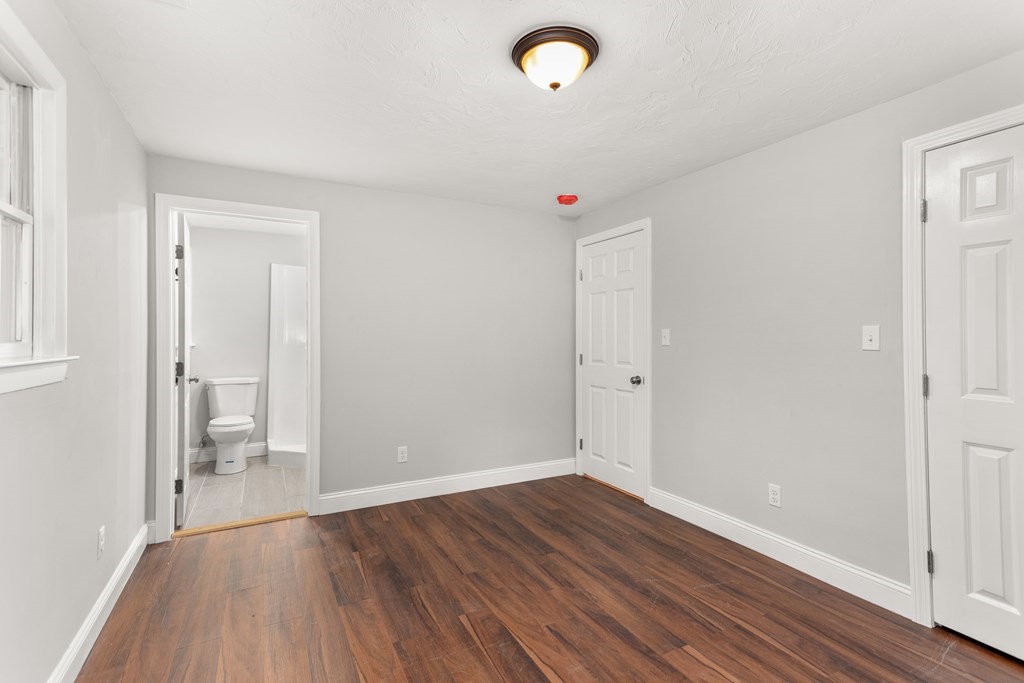 14 Fairbrook Road Framingham, MA 01701 - Photo 19 of 24 an empty room with wooden floor and windows